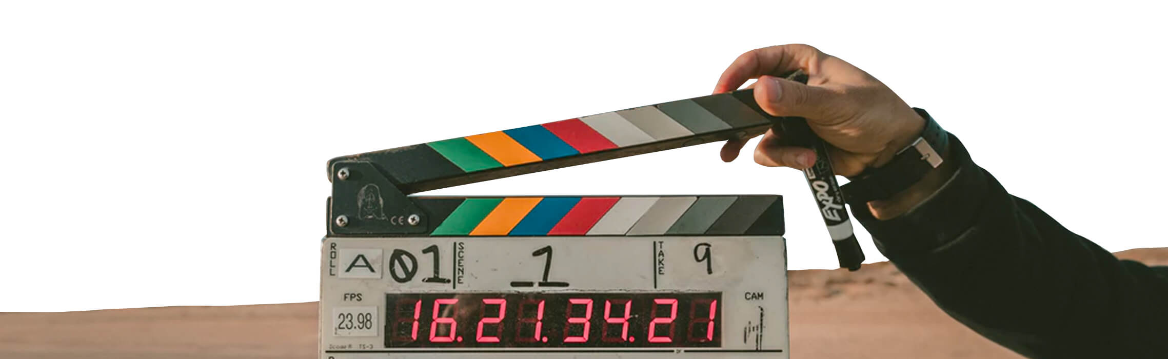 Person holding a movie clapperboard with a countdown timer.