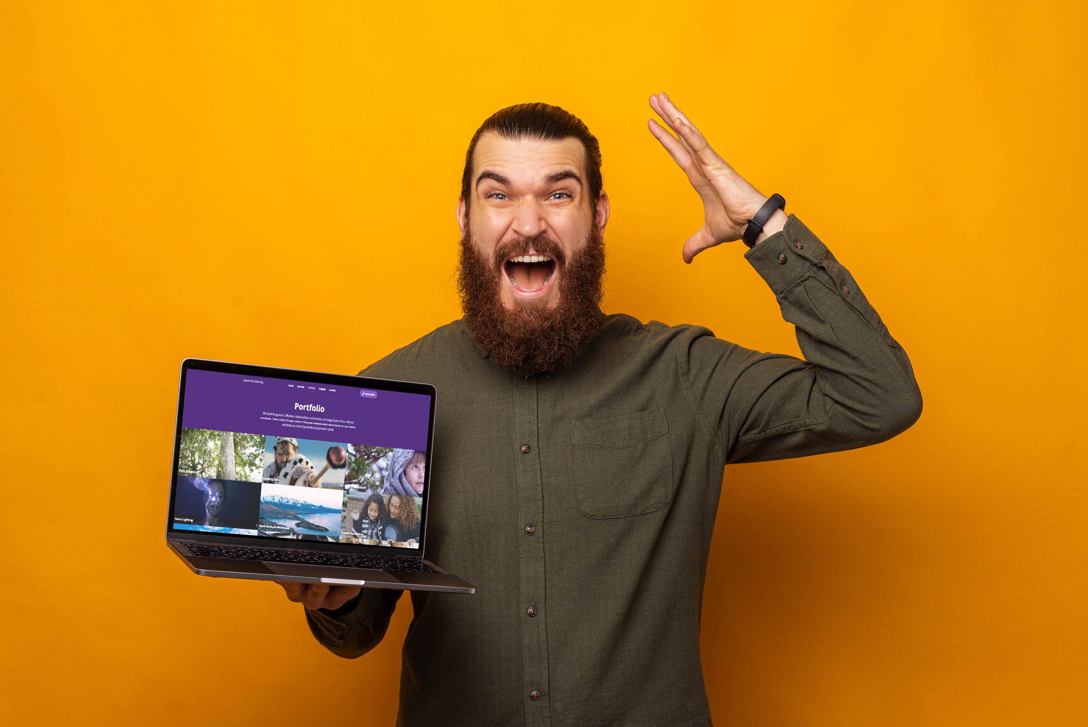 Man holding laptop excited about website design and development for New Zealand businesses by Mantis Digital.